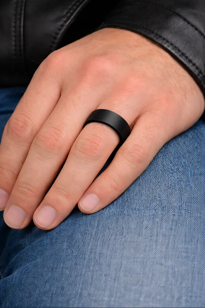 brushed-black-tungsten-ring-flat-on-hand-tc001b.webp