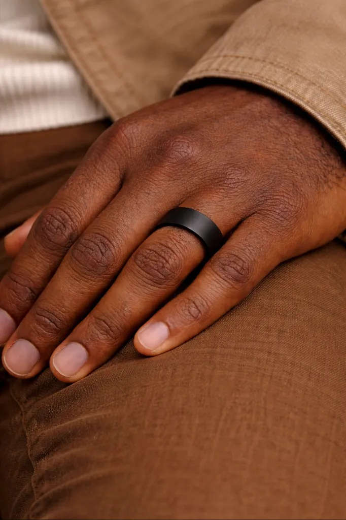 ring-on-mans-hand-8mm-black-ring-flat.webp