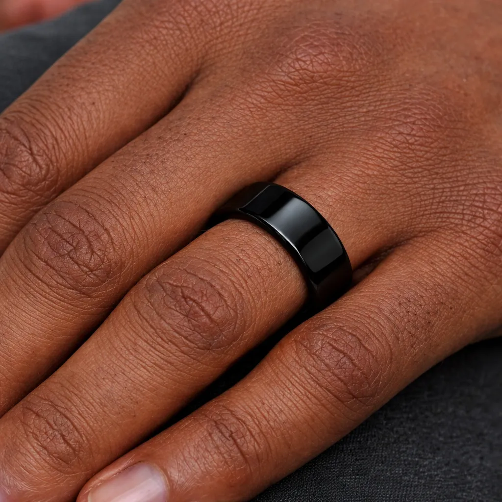polished-black-tungsten-carbide-ring-flat-on-hand-2.webp