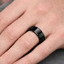 polished-black-tungsten-carbide-ring-flat-on-hand.webp