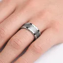 flast-tungsten-ring-with-brushed-center-polished-edges-on-hand.webp