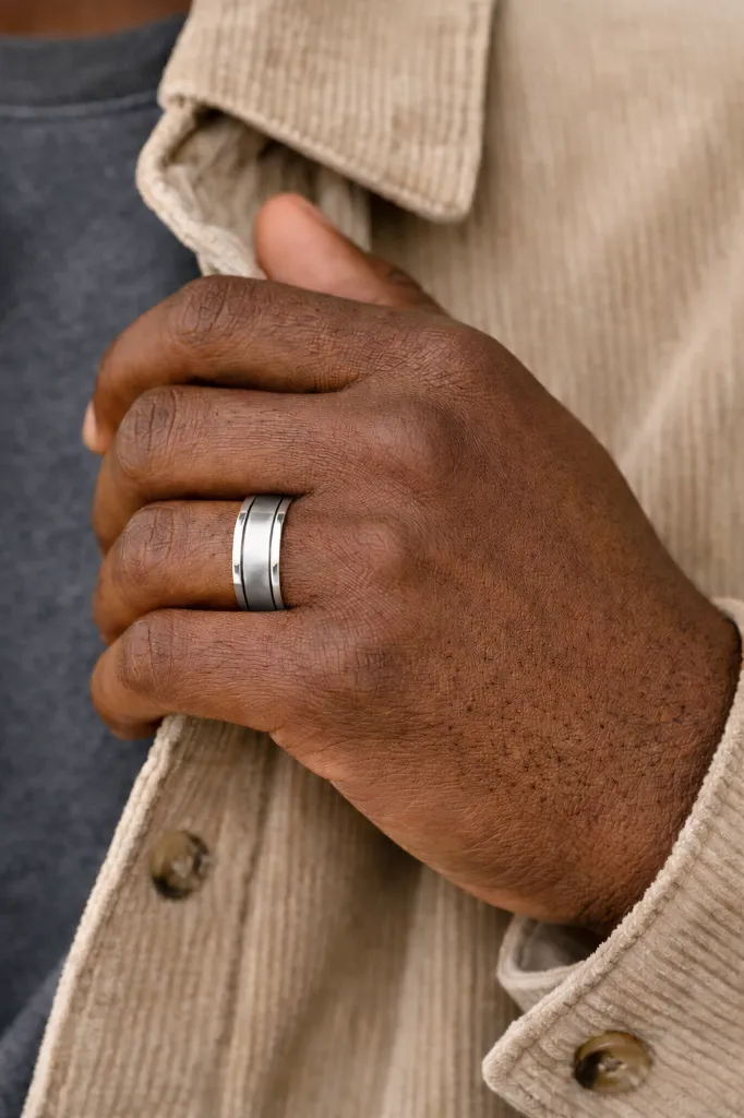 flat-tungsten-ring-with-brushed-center-polished-edges-grooved-on-hand-2.webp