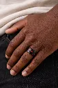 black-ceramic-ring-with-red-stone-inlay-carbon-fiber-on-hand-2.webp
