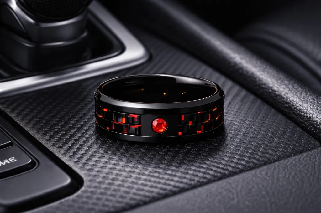 black-ceramic-ring-with-red-stone-inlay-carbon-fiber-in-car.webp